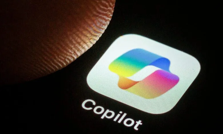Close-up of a finger touching the Copilot app icon on a smartphone screen.