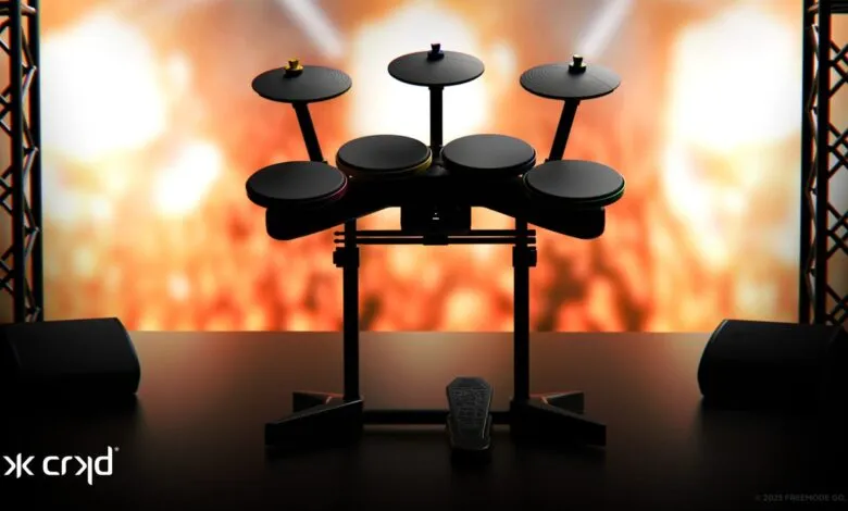 A black electronic drum kit with colorful accents on a stage with a fiery background.