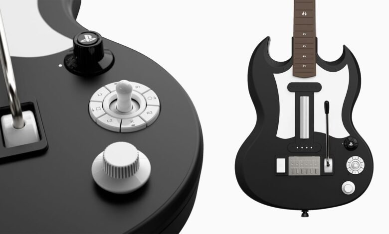 Close-up of a black and white PlayStation guitar controller with buttons and joystick.