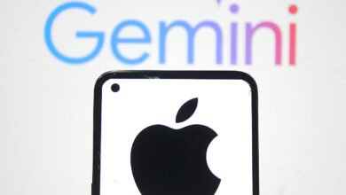 Close-up of a smartphone displaying the Apple logo, with the Google Gemini logo blurred in the background.