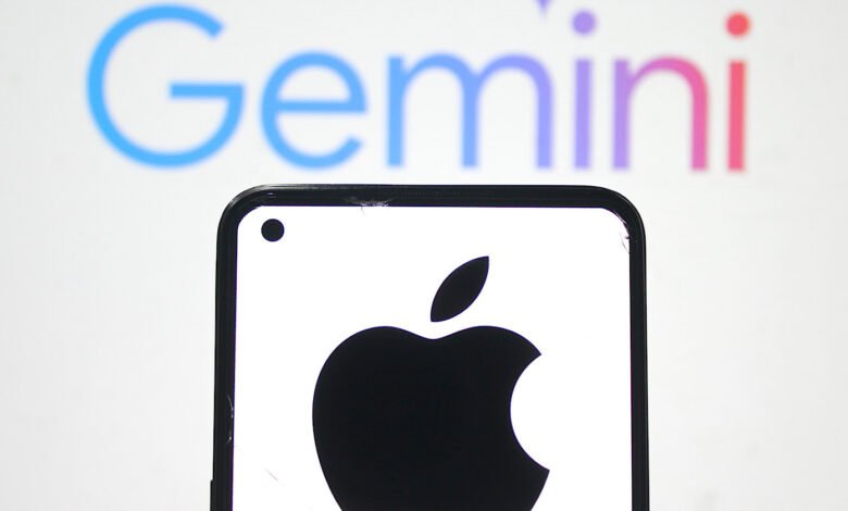 Close-up of a smartphone displaying the Apple logo, with the Google Gemini logo blurred in the background.