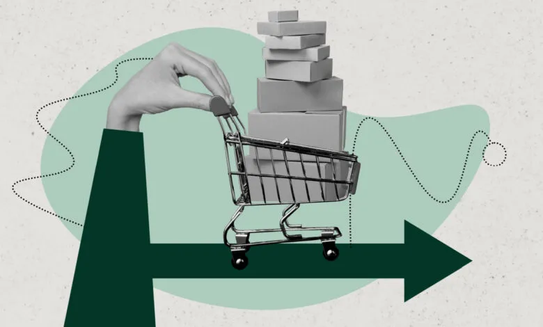 Hand pushing a shopping cart filled with boxes, with a graph and arrow indicating trends.