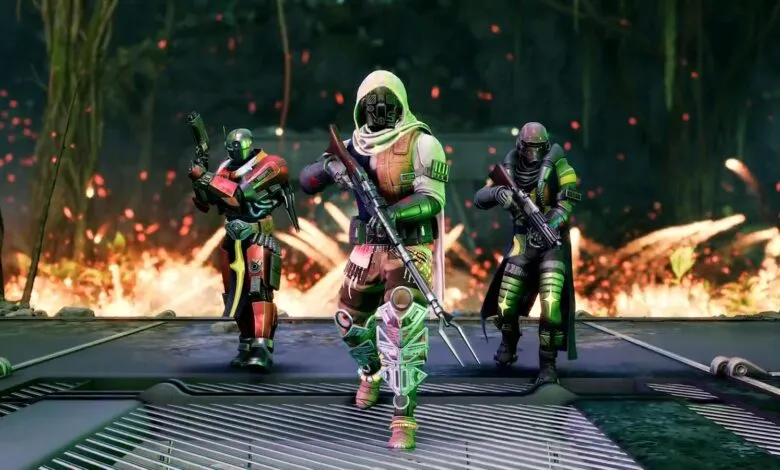 Three futuristic soldiers in colorful armor stand in a fiery jungle environment.