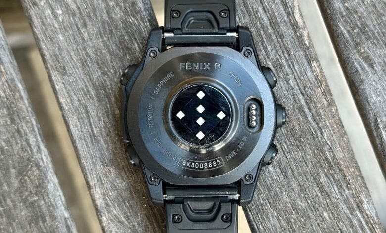 Close-up of the back of a Garmin Fenix 8 watch showing sensors and specifications.
