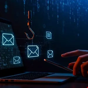 Cybersecurity concept showing a phishing hook targeting email icons on a laptop screen.