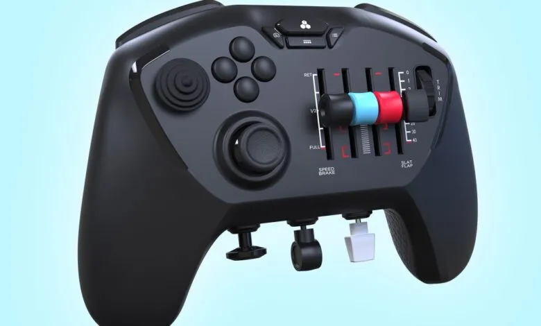 Close-up of a black flight simulator controller with sliders and buttons.