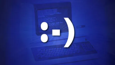 A large white smiley face emoticon superimposed over a vintage computer screen and keyboard.