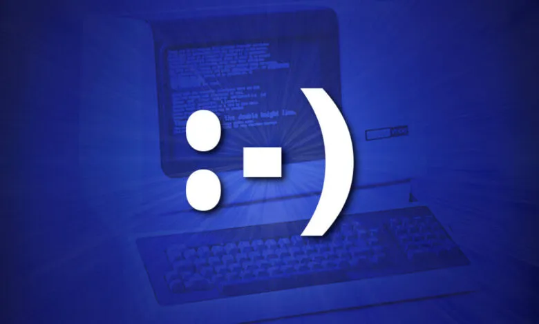 A large white smiley face emoticon superimposed over a vintage computer screen and keyboard.