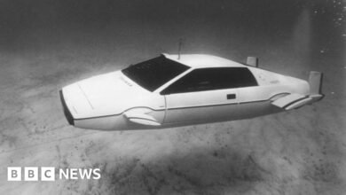 A white Lotus Esprit submarine car submerged underwater.