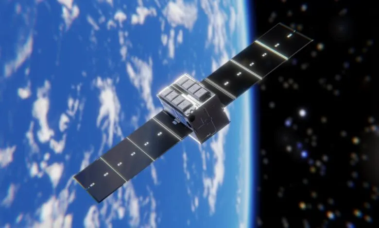 Satellite with solar panels orbiting Earth against a starry background.