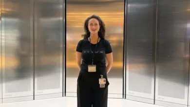 Genya Crossman stands in front of IBM's utility-scale quantum computer system.