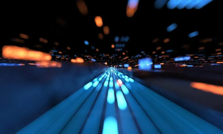 Abstract digital tunnel with glowing blue and orange lights, suggesting speed and data flow.