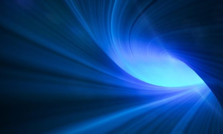 Abstract blue light tunnel with swirling motion effect.