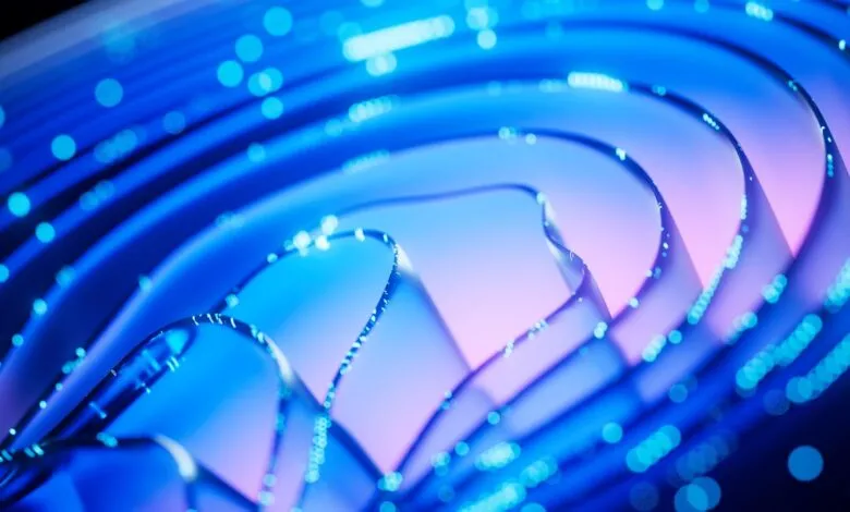 Abstract blue and purple wavy lines with glowing blue dots, representing data flow or technology.