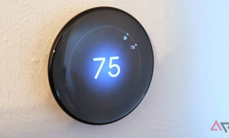 Google Nest Thermostat displaying 75 degrees Fahrenheit on a wall.