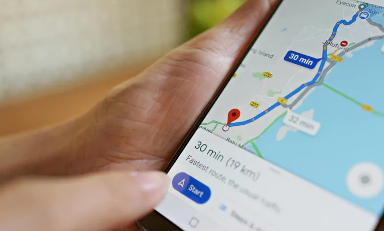 Close-up of a person using a smartphone with Google Maps navigation displayed.