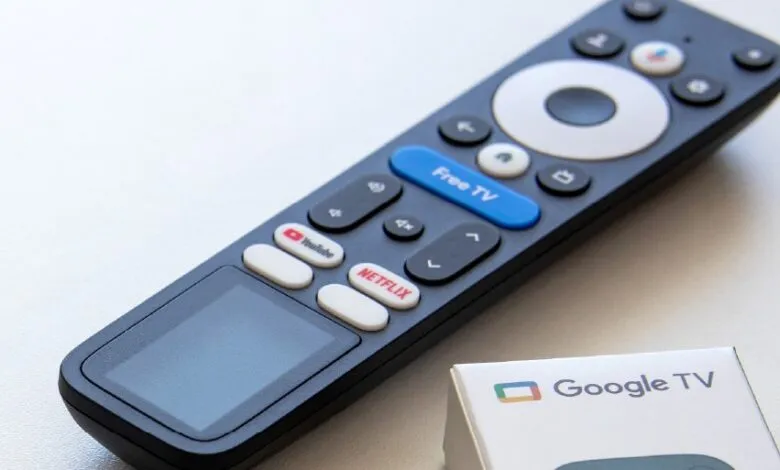 Close-up of a Google TV remote control with dedicated YouTube and Netflix buttons.