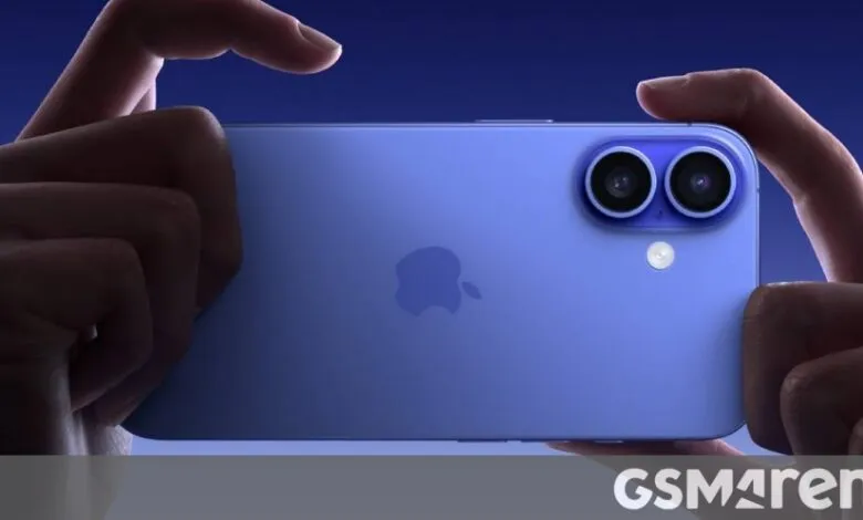 Close-up of hands holding a purple iPhone with dual cameras.
