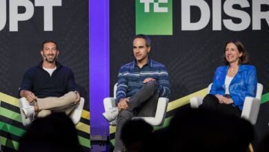 Three panelists sit on stage at TechCrunch Disrupt conference.