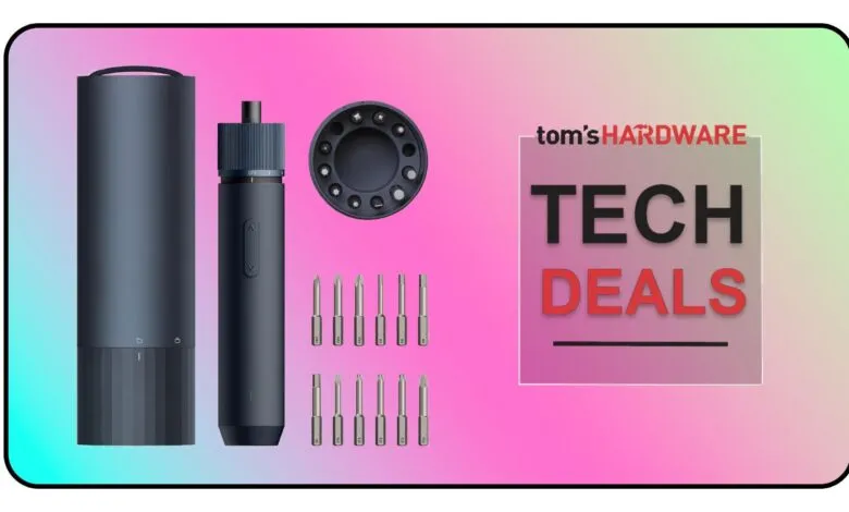 Electric screwdriver set with various bits and a charging stand.