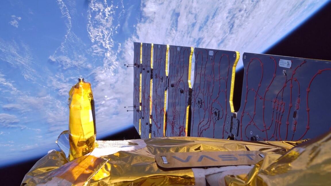 Close-up view of a spacecraft in orbit above Earth, showing solar panels and reflective insulation.