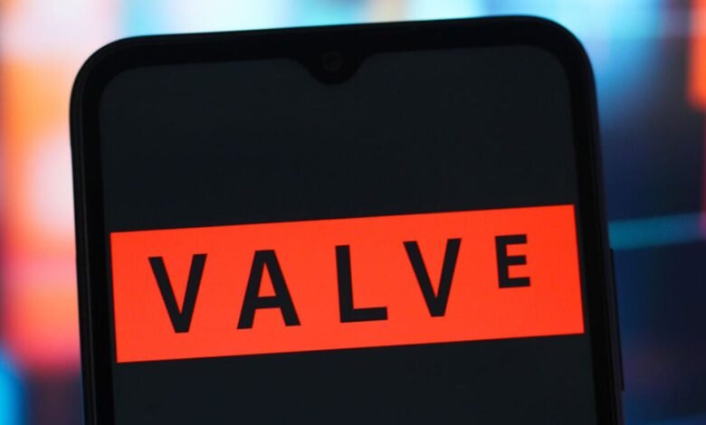 Close-up of a smartphone displaying the Valve logo on a black screen.