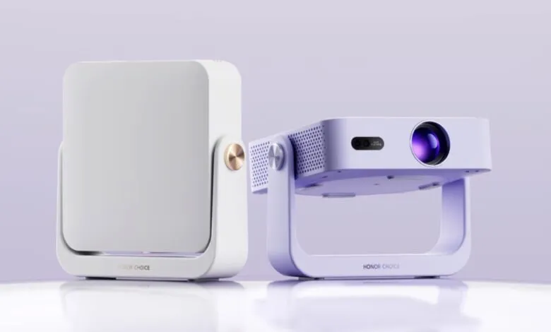 Two Honor Choice AI Projector Air 1 devices, one white and one lavender, on a light surface.