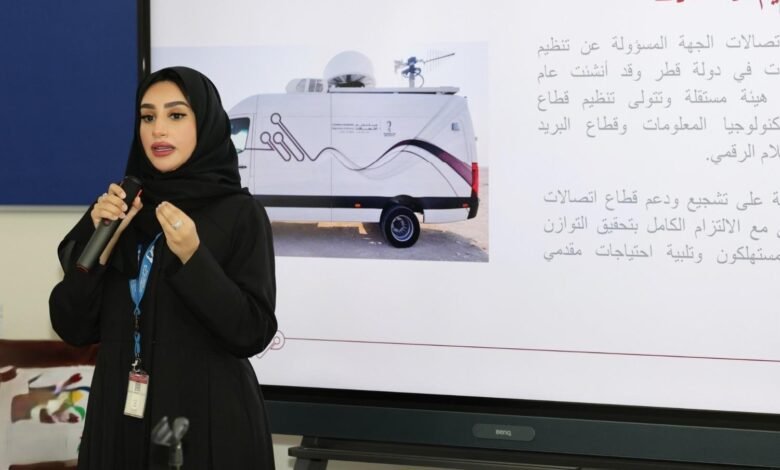 Woman in hijab speaking into a microphone, with a presentation slide showing a broadcast van.
