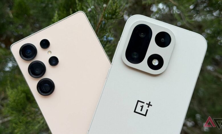 Close-up of the camera arrays on two modern smartphones, one beige and one white.