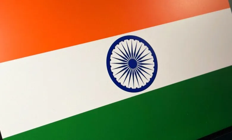 Close-up of the Indian flag, showing the saffron, white, and green bands with the Ashoka Chakra.