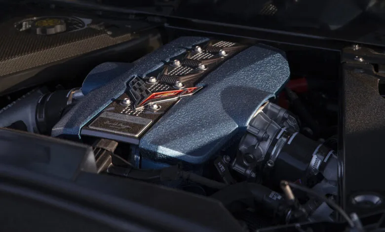 Close-up of a Corvette engine with a textured blue cover and chrome accents.
