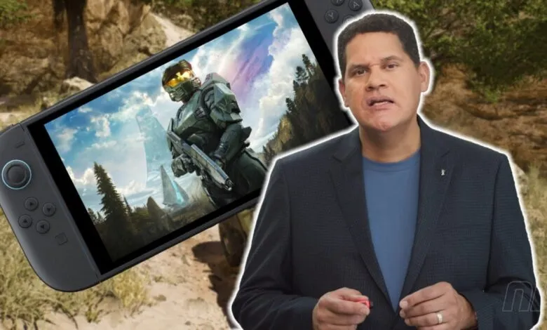Reggie Fils-Aimé holding a Nintendo Switch displaying Halo Infinite gameplay.