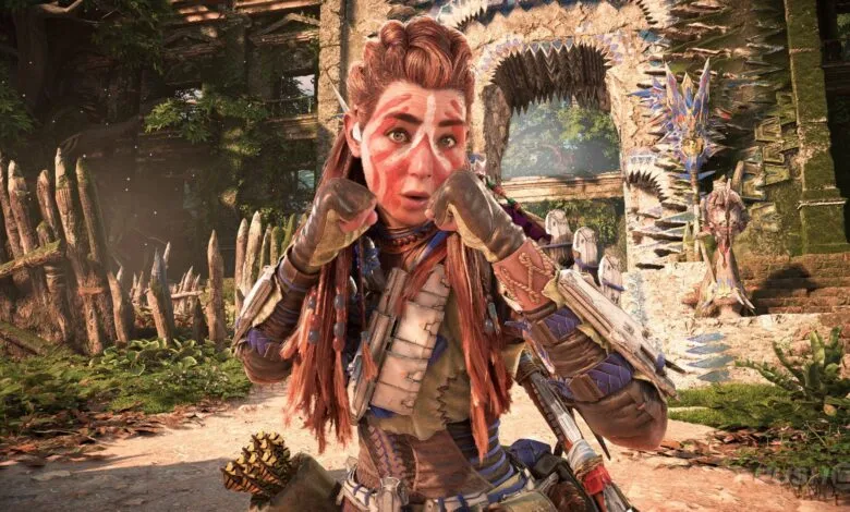 Aloy from Horizon Forbidden West with war paint on her face, fists raised.