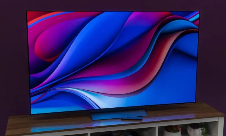 LG OLED TV displaying vibrant abstract art in blue, pink, and purple.
