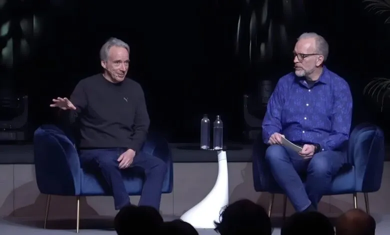 Linus Torvalds and another man sit on stage discussing technology.