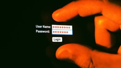 Finger pressing login button on screen with username and password fields.