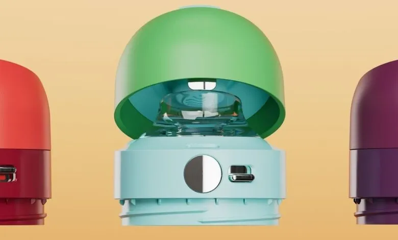 Three colorful, modern portable speakers in red, green, and purple.