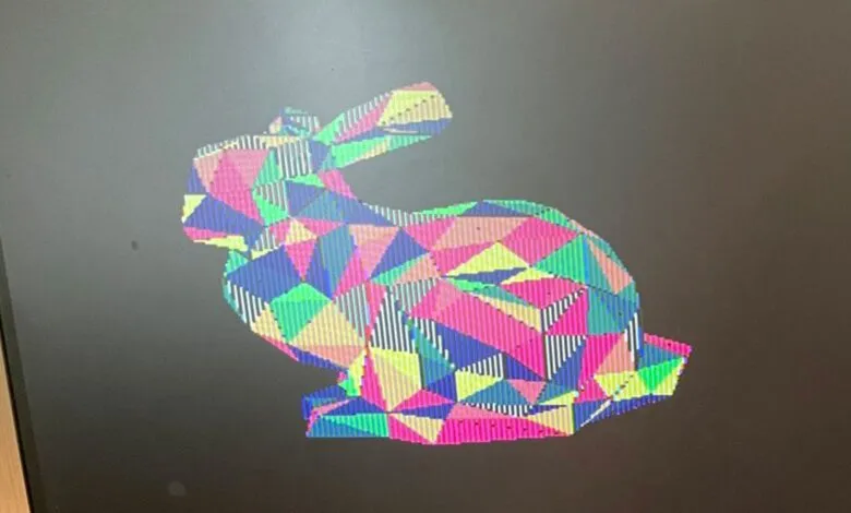 A 3D rendered bunny silhouette filled with colorful geometric triangles and stripes.