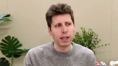 Sam Altman, CEO of OpenAI, speaking during an interview, wearing a grey sweater.