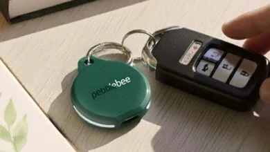 A green Pebblebee tracker attached to a car key fob.