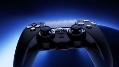 Close-up of a black PlayStation DualSense Edge wireless controller against a blue gradient background.