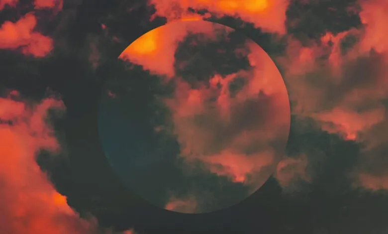 Dramatic red and dark clouds with a circular overlay.