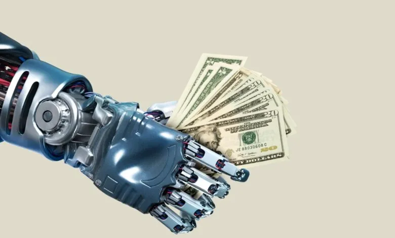 A robotic hand holding a fan of US dollar bills.