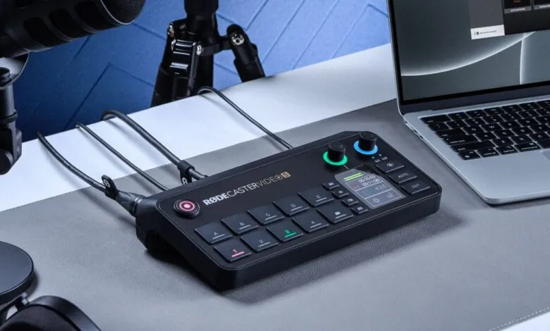Rodecaster Pro II audio mixer with microphones and laptop on a desk