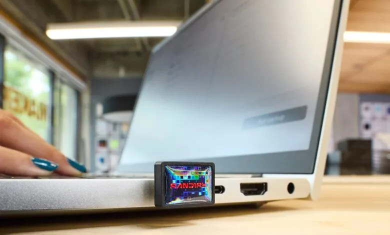 A SanDisk Extreme Fit 1TB USB drive plugged into a laptop.