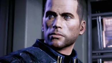 Close-up of Commander Shepard's face, a human male with blue eyes and short brown hair.