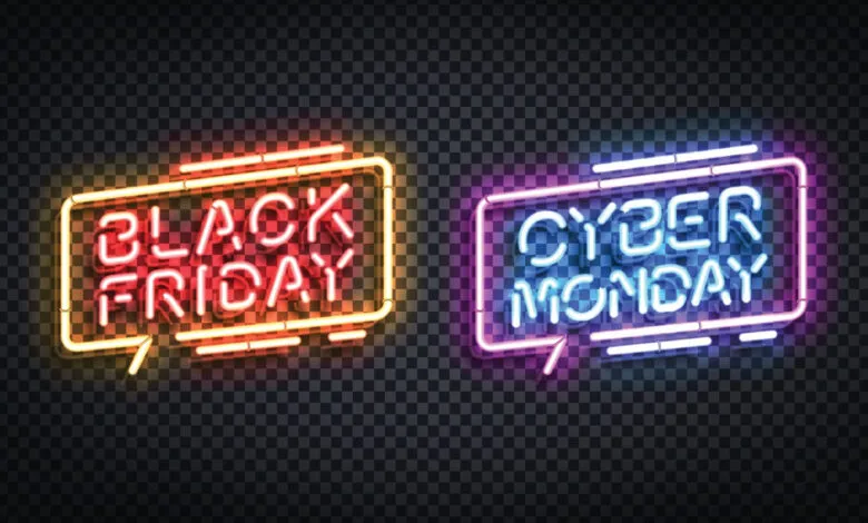 Neon signs reading 'Black Friday' and 'Cyber Monday' on a dark background.