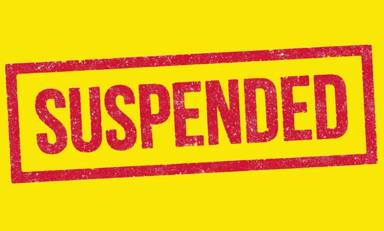 A red stamp with the word SUSPENDED in distressed uppercase letters on a bright yellow background.