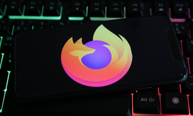 Smartphone displaying the Firefox logo on a backlit keyboard.