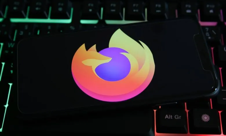 Smartphone displaying the Firefox logo on a backlit keyboard.